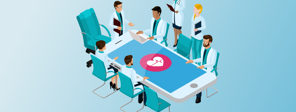 Medical professionals sitting around an iPhone table with a heart beat displayed on screen